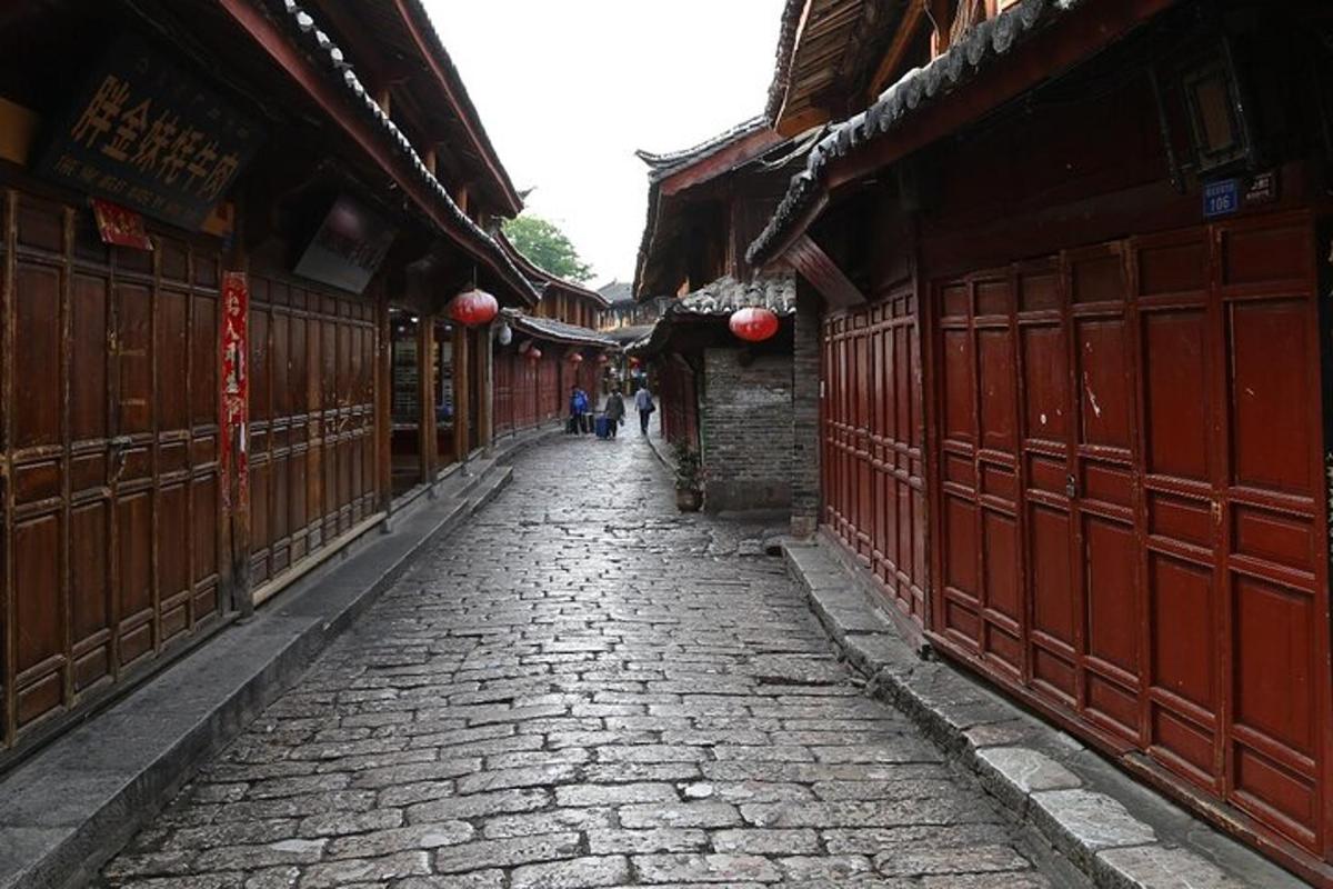 a stone alley with red gates in an asian building