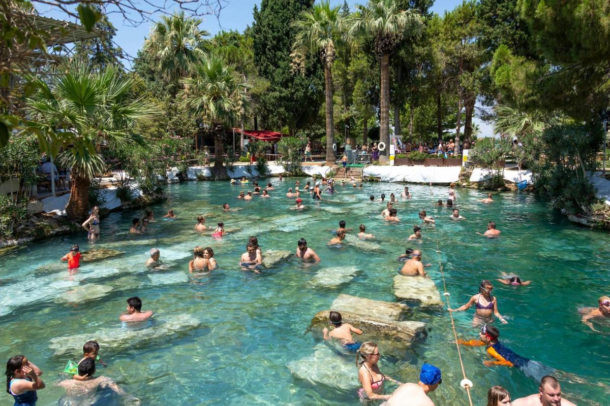 a group of people in the water at a swimming pool