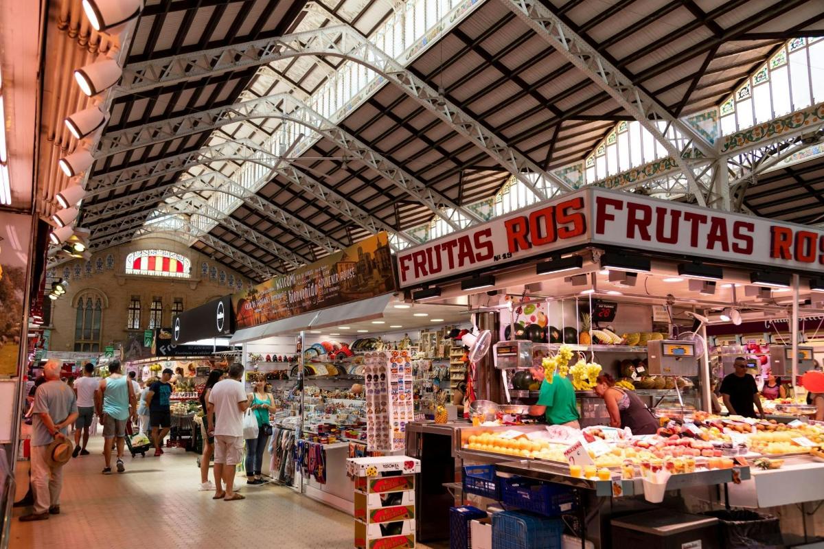 a market with people walking around a market with food