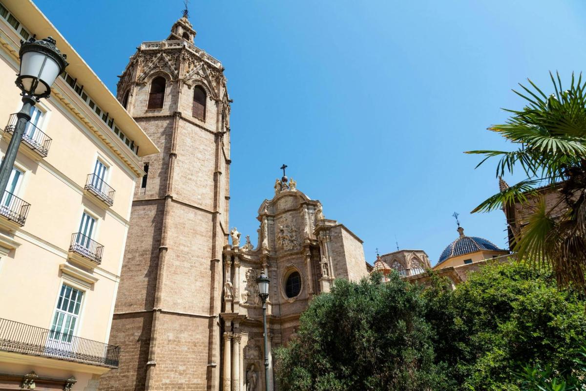 an old church with a tower in front of a building