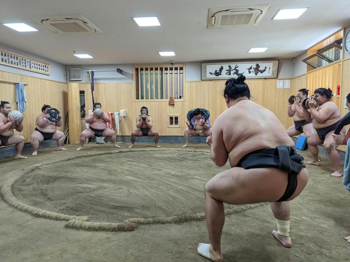 a group of men in bathing suits in a ring