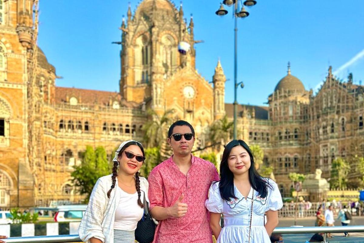 a group of three people standing in front of a building