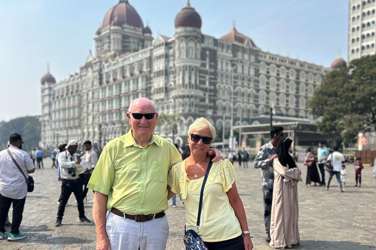 a man and a woman standing in front of a building