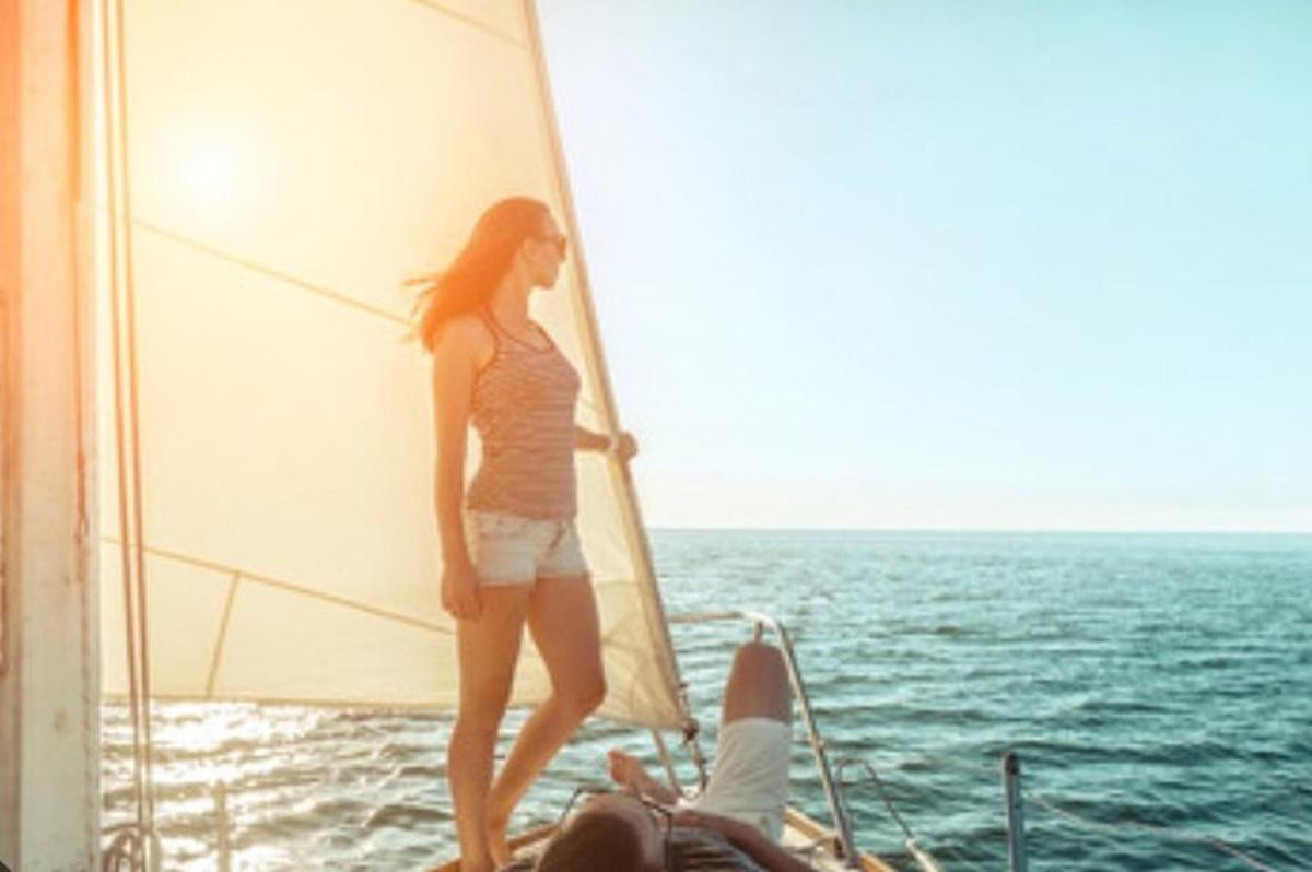 a woman standing on a sail on a boat