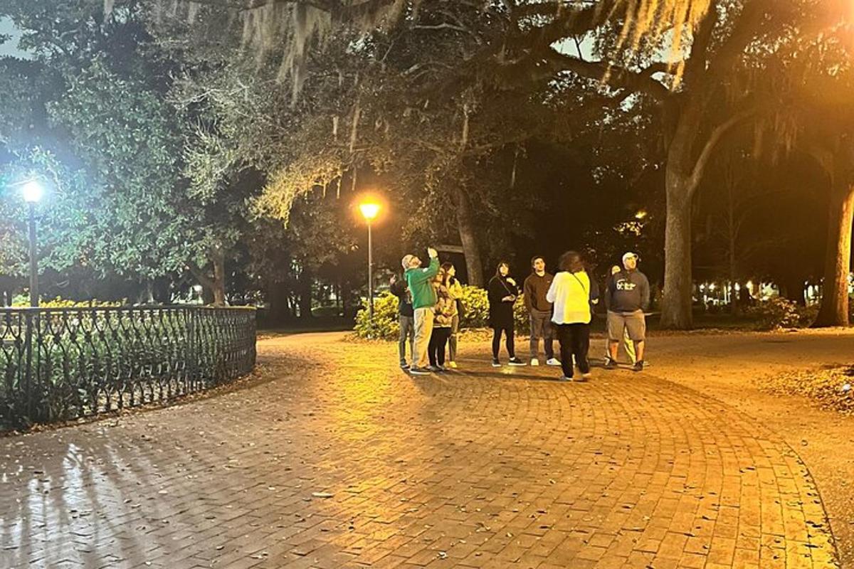 a group of people walking down a street at night