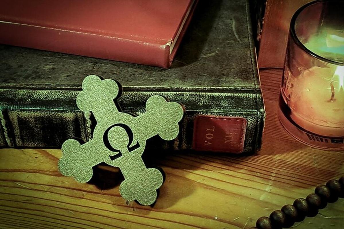 a small green ornament on a table next to a candle