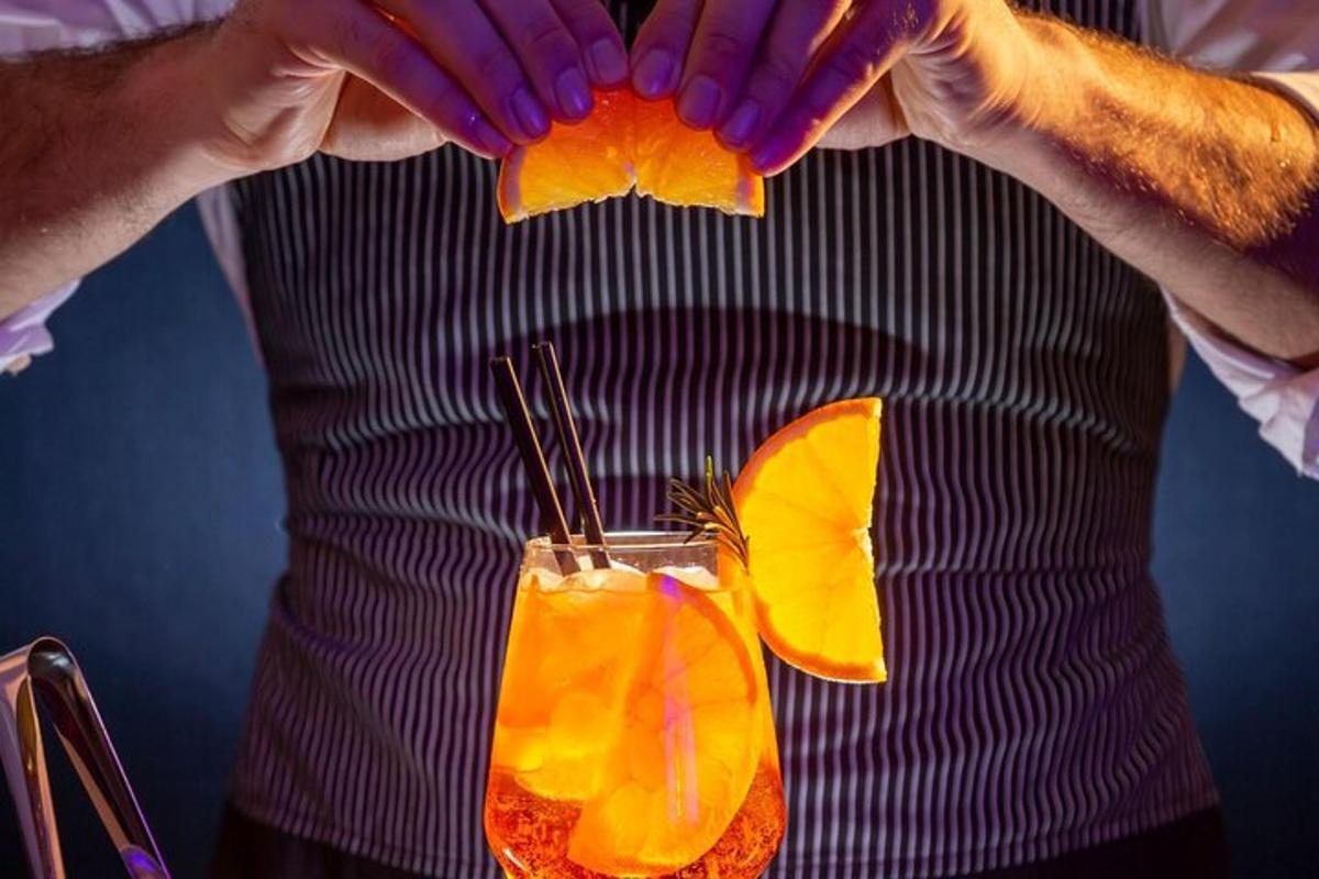 a man holding his hands above a drink