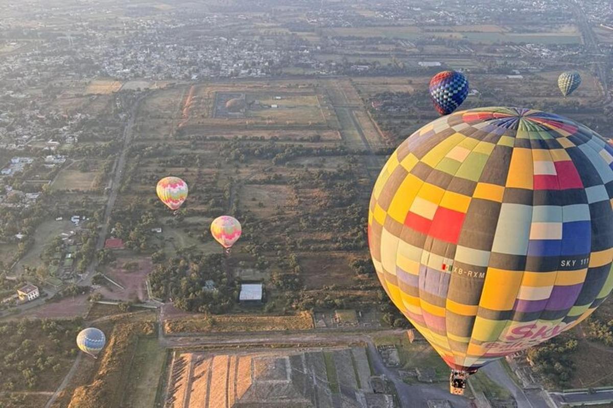 a group of hot air balloons flying over a city