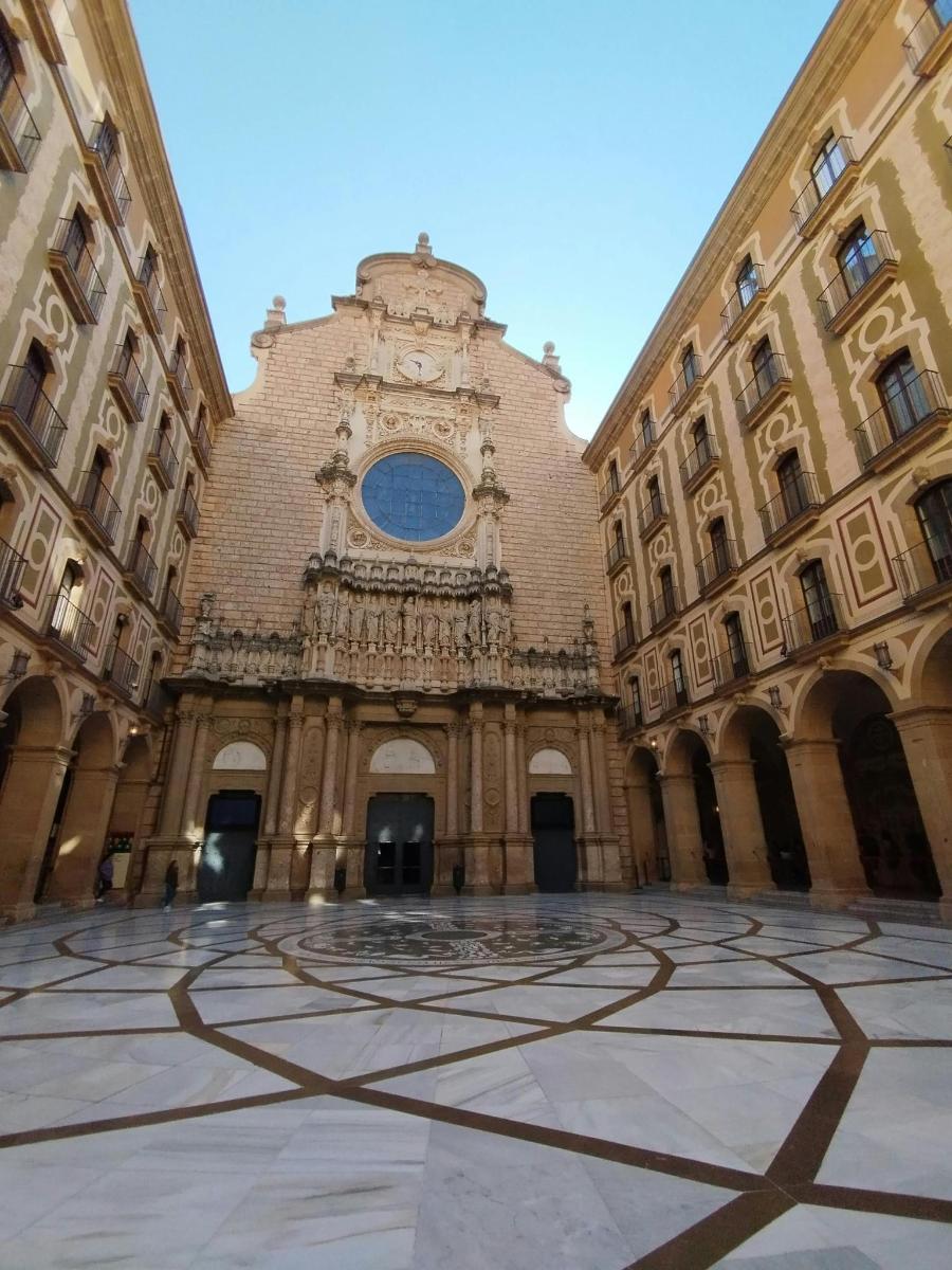 a large building with a clock tower in a courtyard