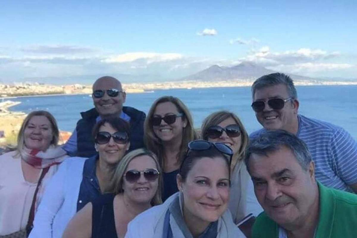 a group of people posing for a picture at the beach