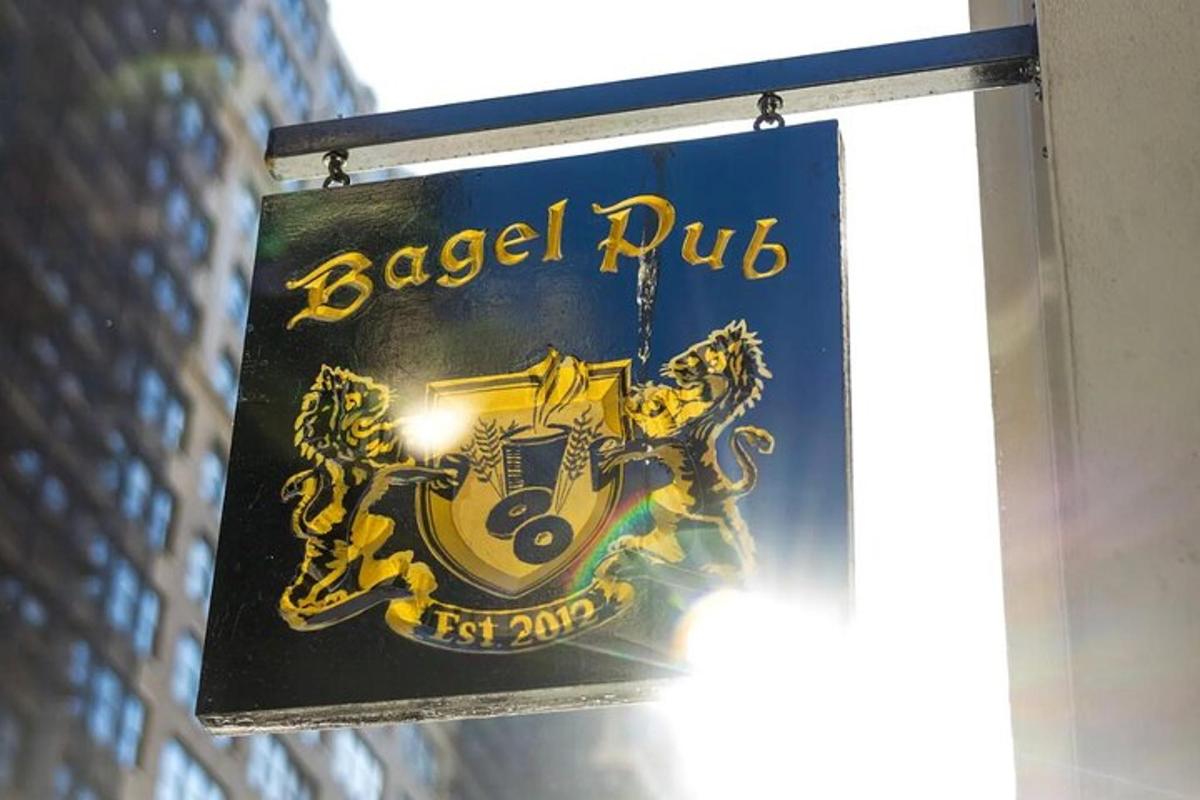 a sign for a bagel pub hanging from a building