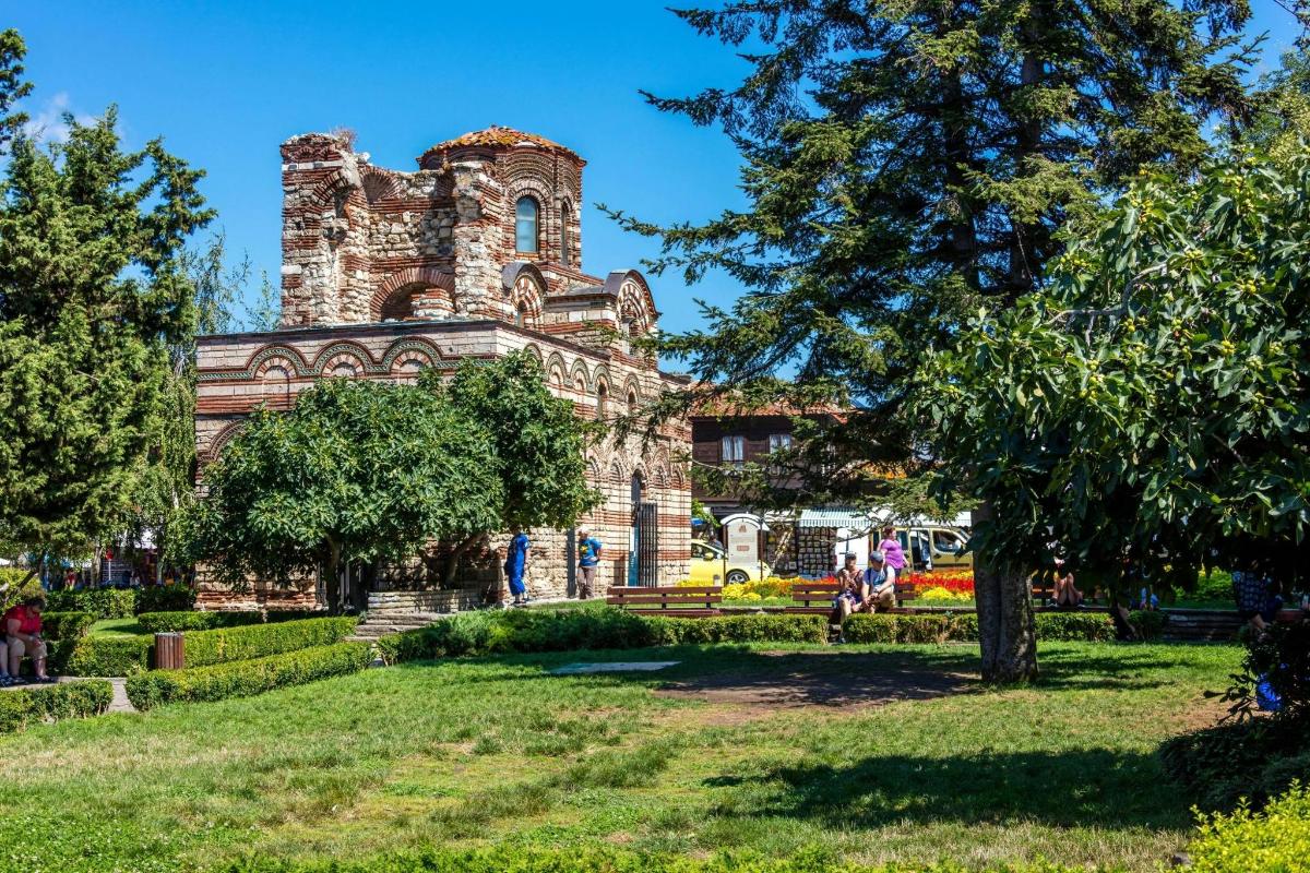 an old building with a tower in a park