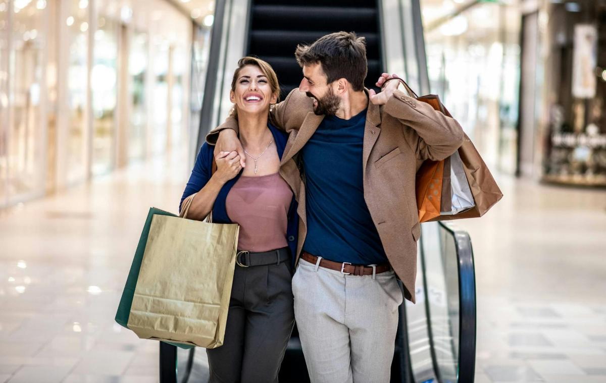 a man and a woman standing in a shopping mall
