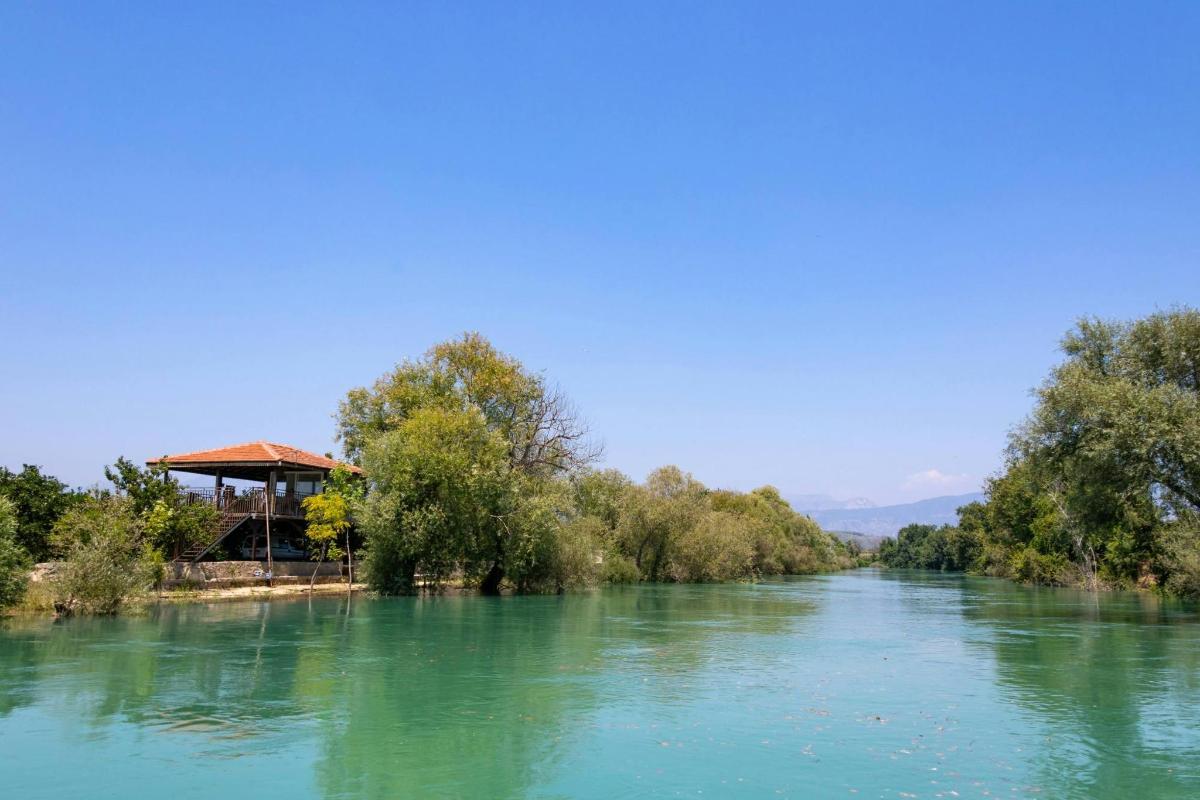 a river with a gazebo on the side of it