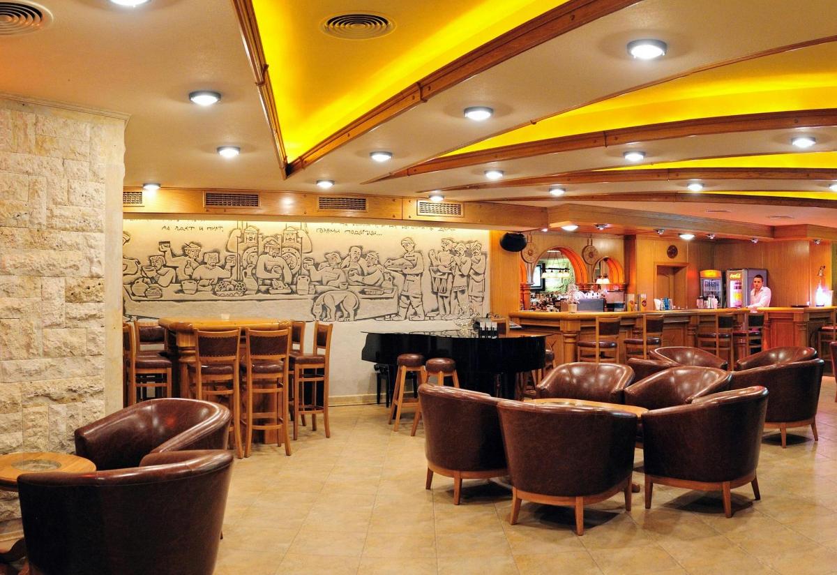 a restaurant with a bar with brown leather chairs