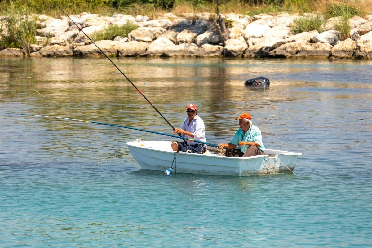 two men are sitting in a boat in the water