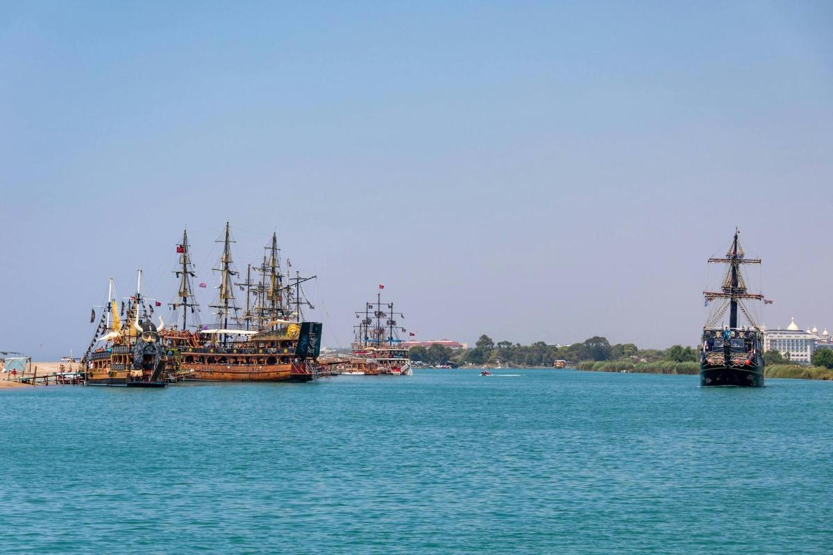 three boats are docked in a large body of water