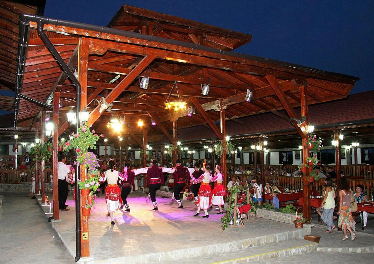 a group of people dancing in a pavilion at night