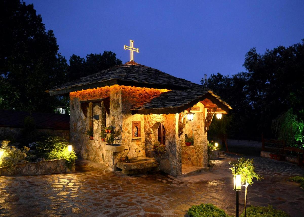 a small chapel with a cross on top of it