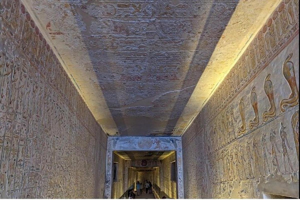 a hallway with paintings on the walls of a building