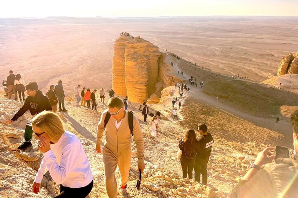 un grup de oameni care stau pe marginea unei stânci