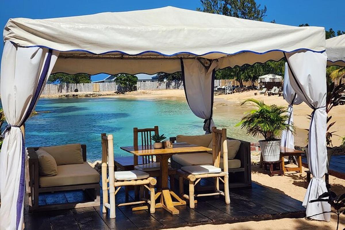 a tent on the beach with a table and chairs