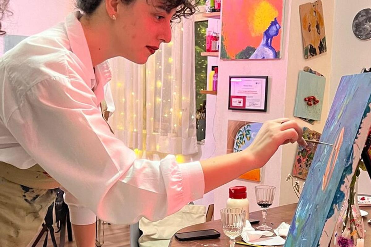 a woman is painting a picture in a room