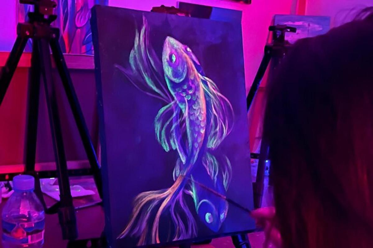 a painting of a fish on a canvas with a camera