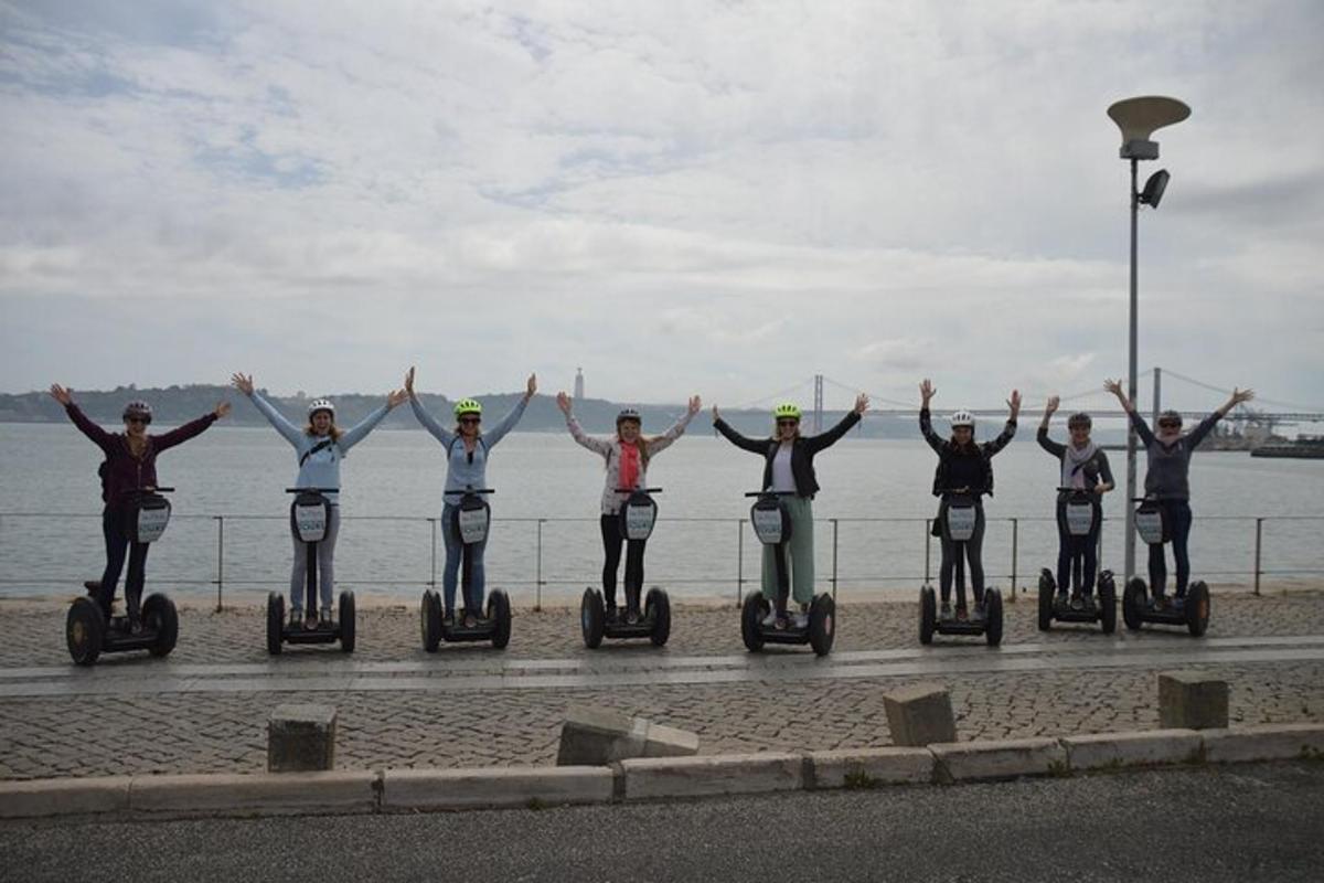 a group of people riding on segways by the water