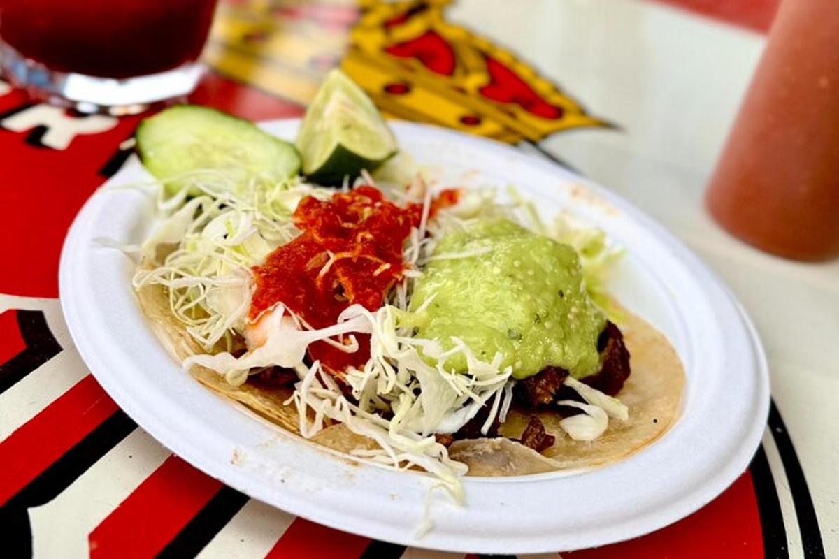 a plate of food with a taco on a table