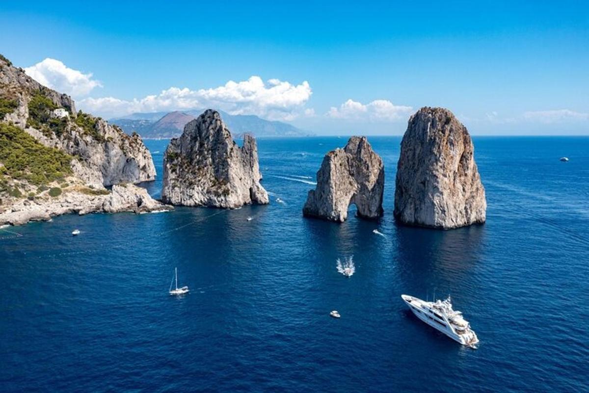 a group of rocks in the water with a boat