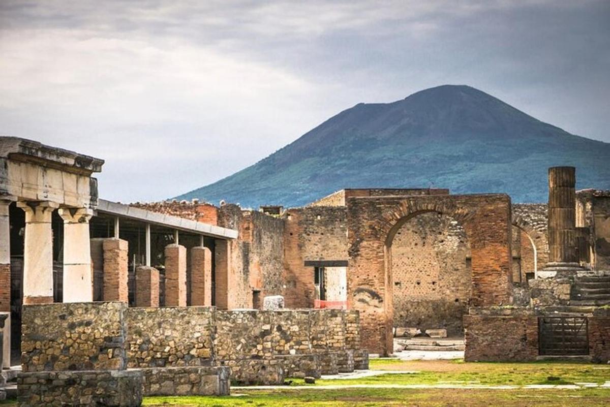 an ancient building with a mountain in the background