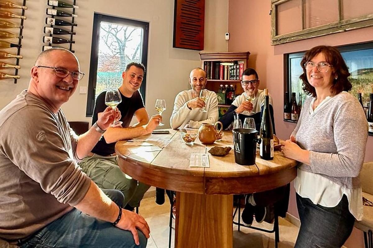 a group of people sitting around a table drinking wine