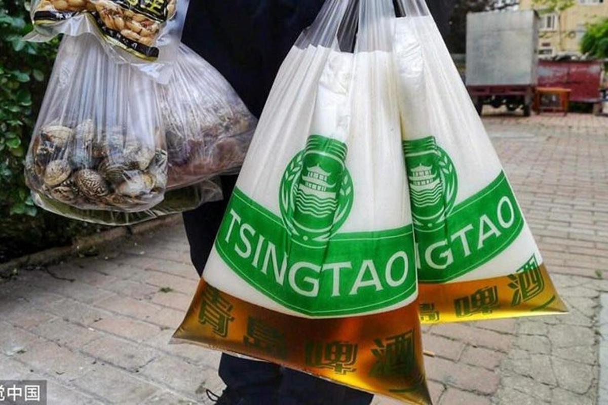 a person holding two bags of bread and food