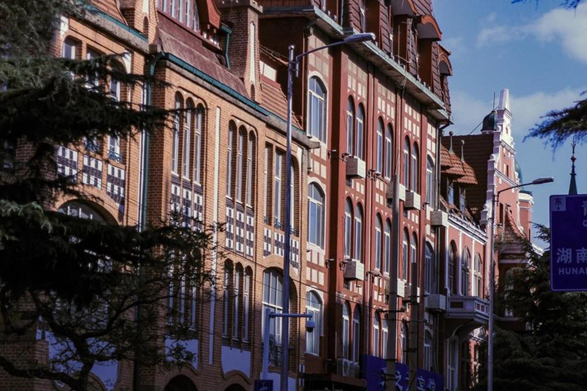 a large brick building with many windows on a street