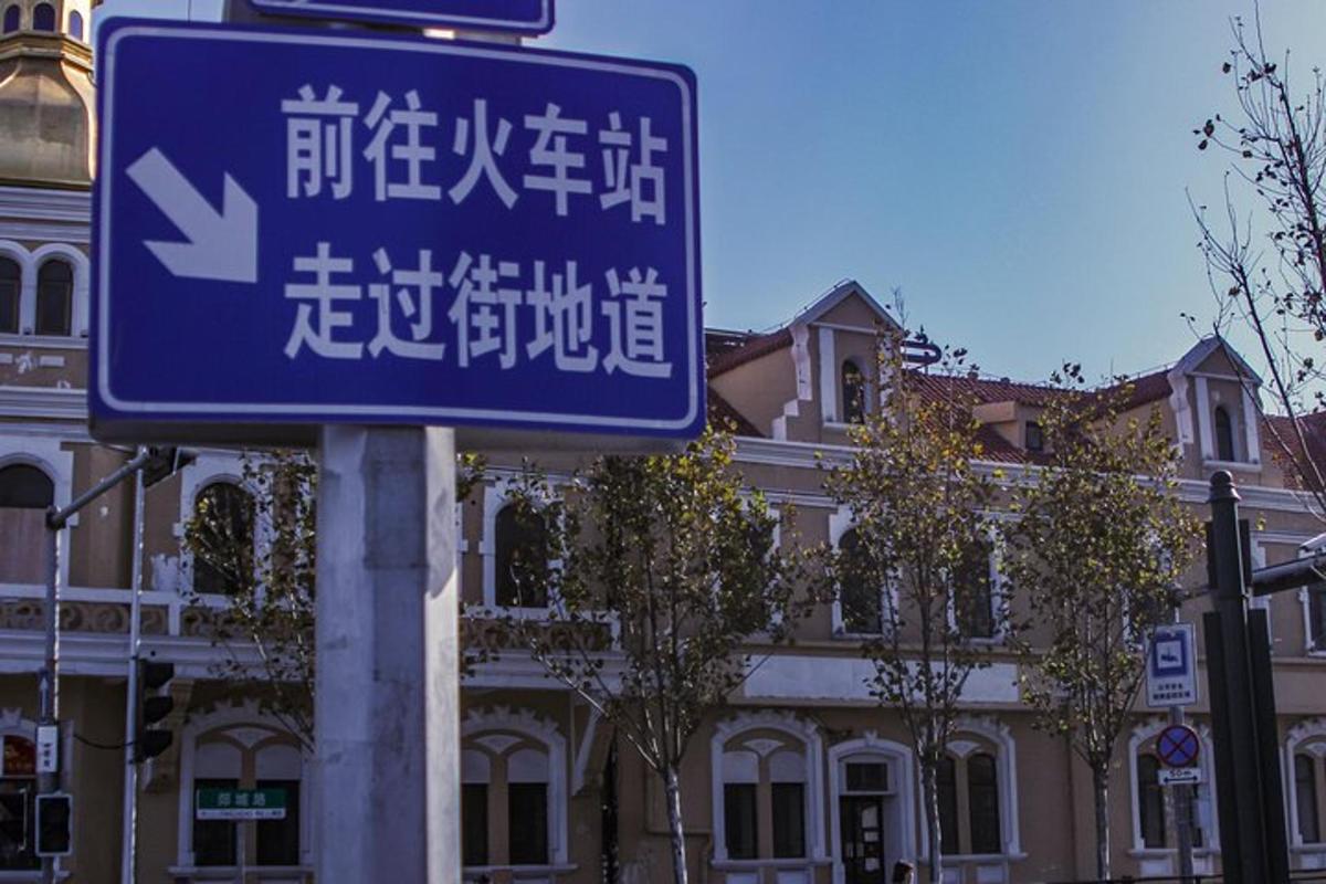 a blue street sign in front of a building