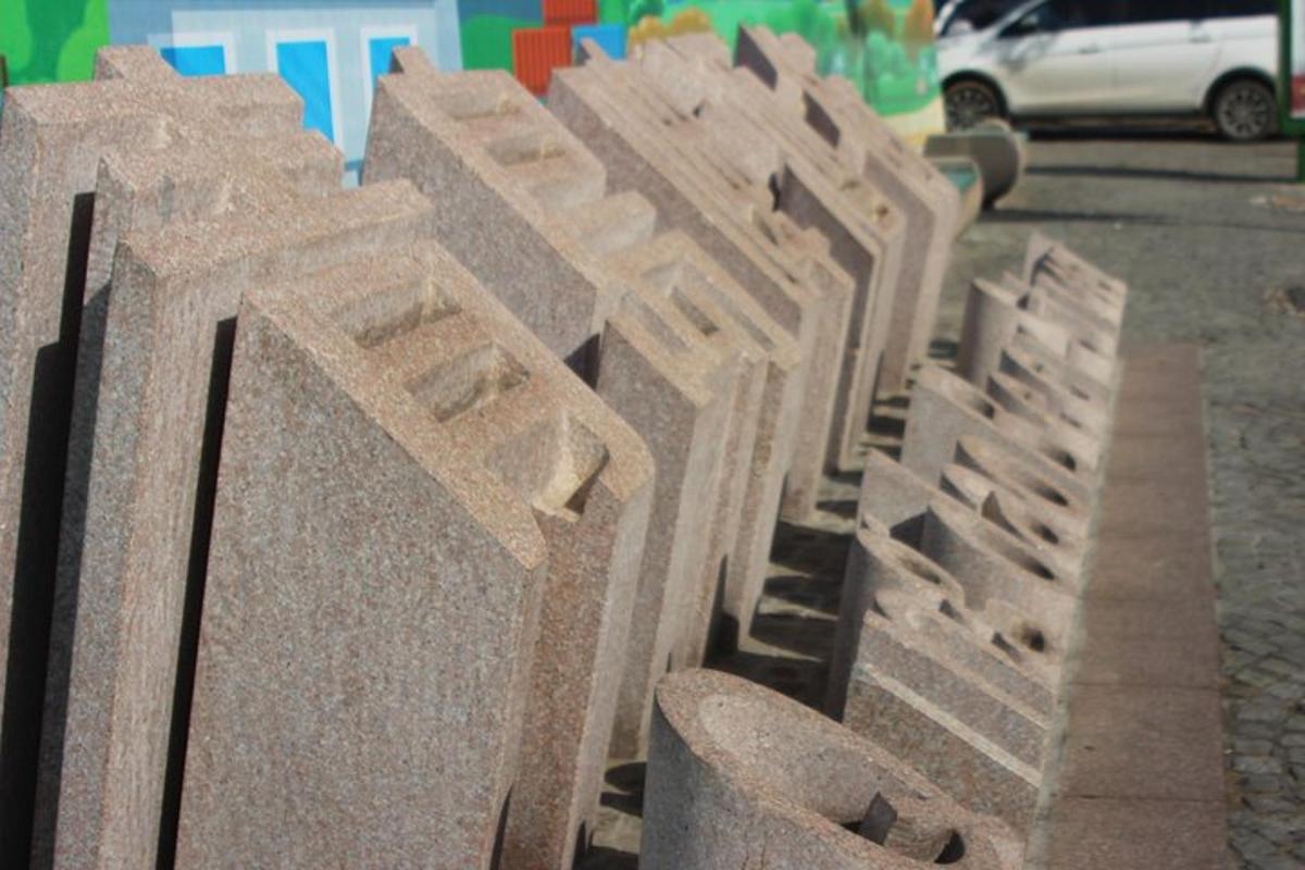 a row of stone crosses on a street