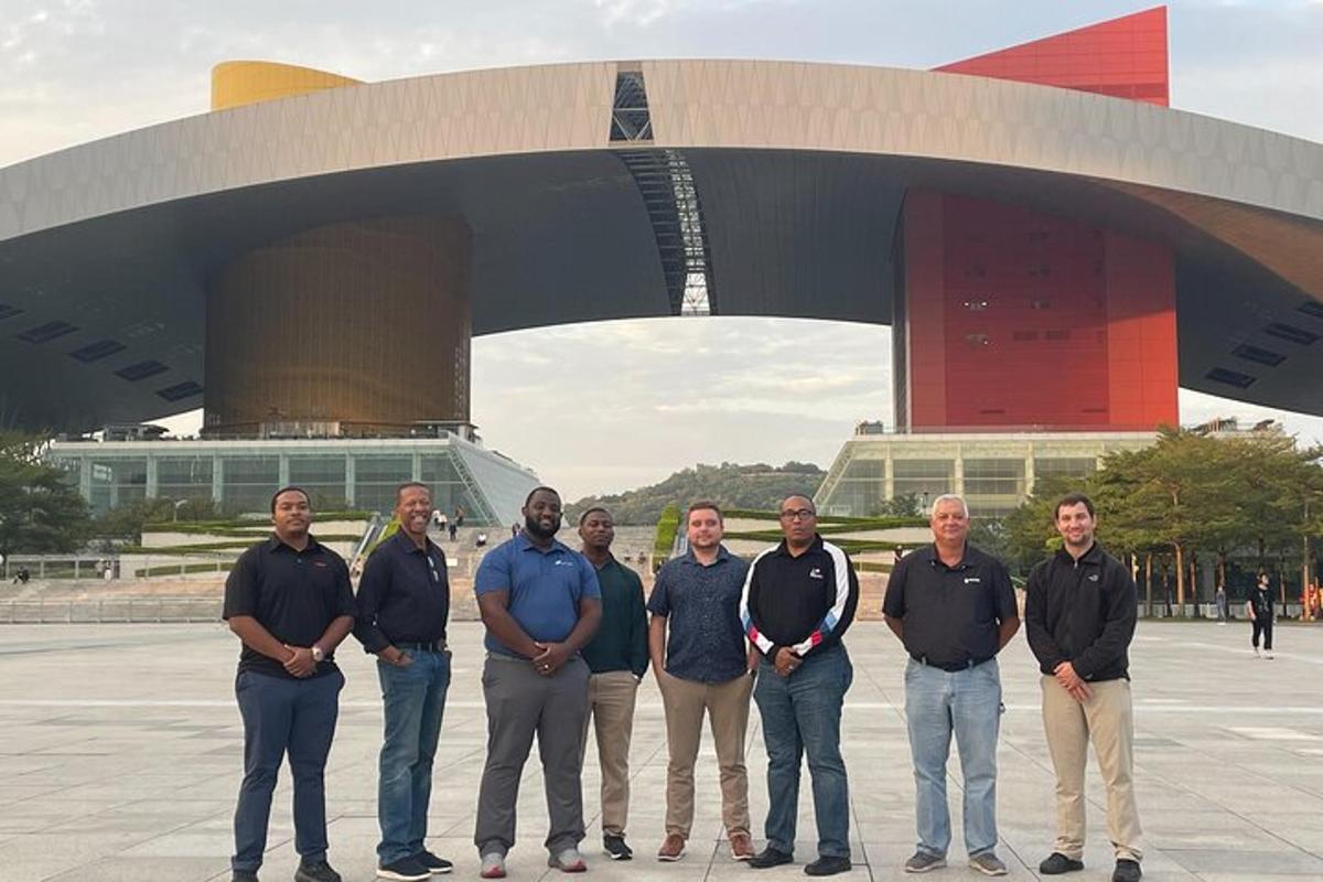 a group of men standing in front of a building