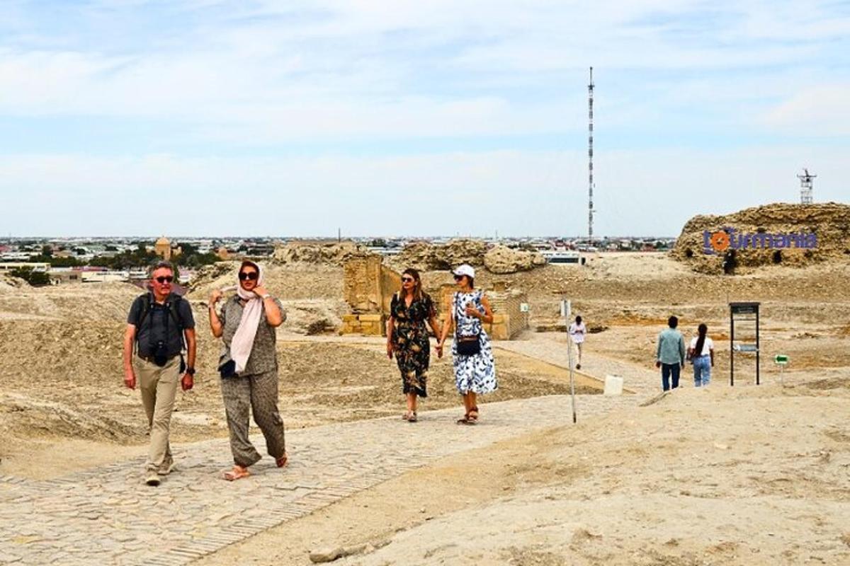 a group of people walking down a dirt road