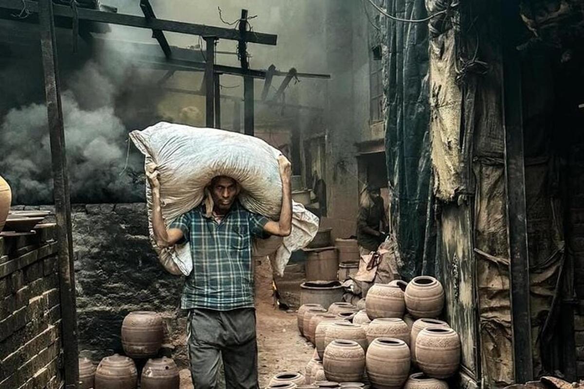 a man carrying a load on his head