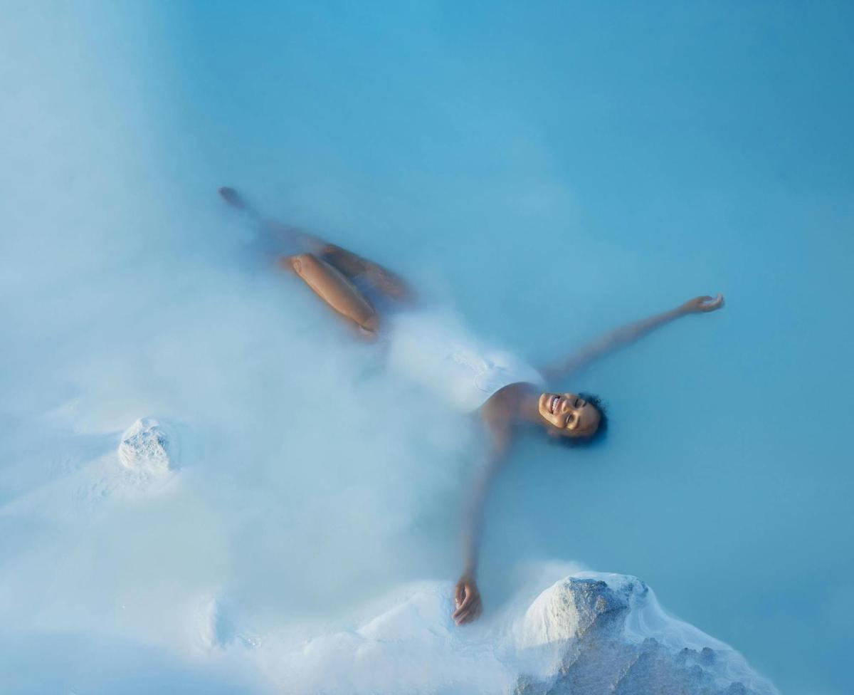 a person on skis flying through the sky
