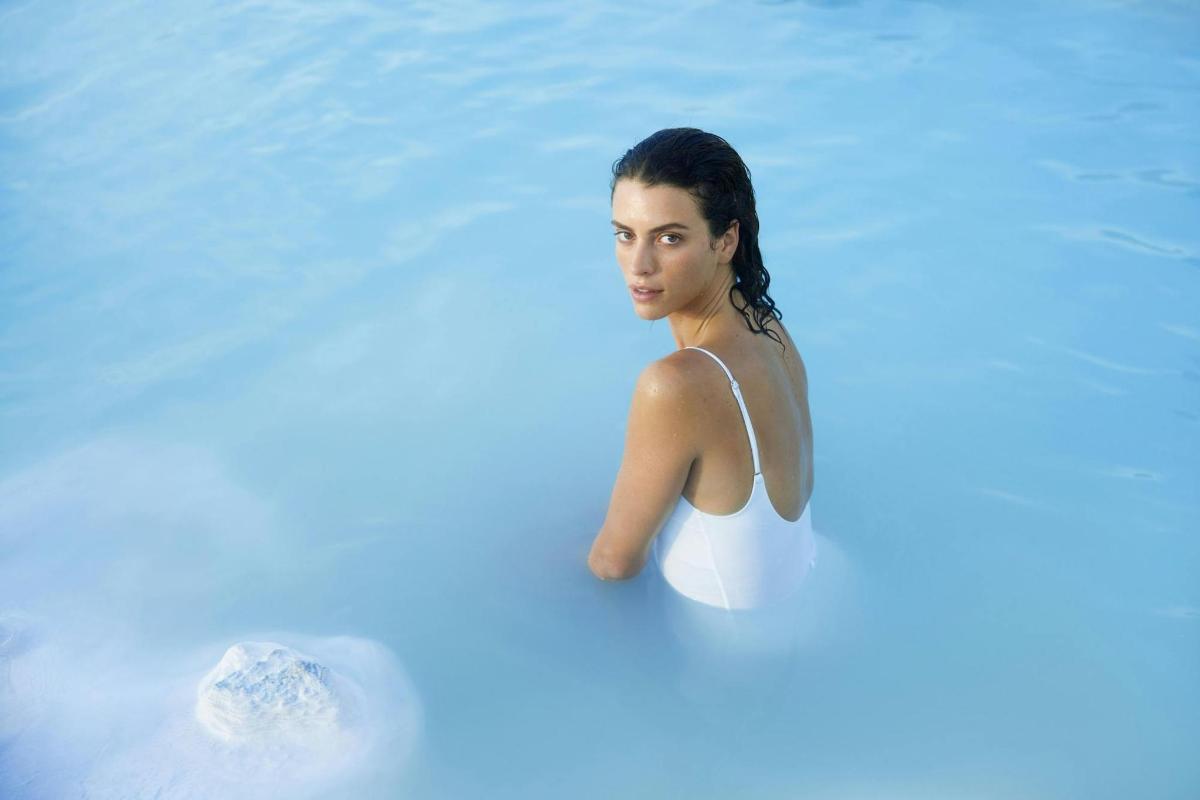 a woman swimming in a pool of water