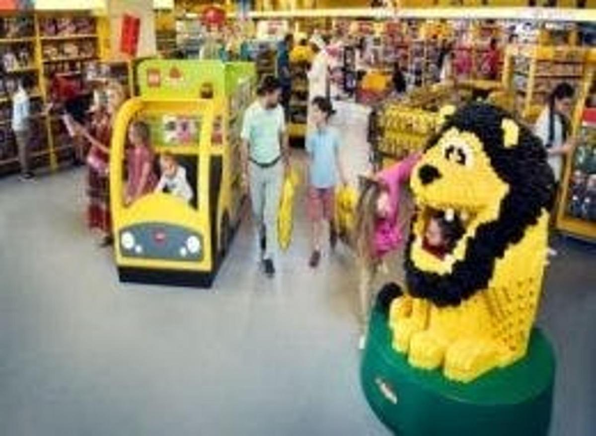 a group of people walking through a store with toys