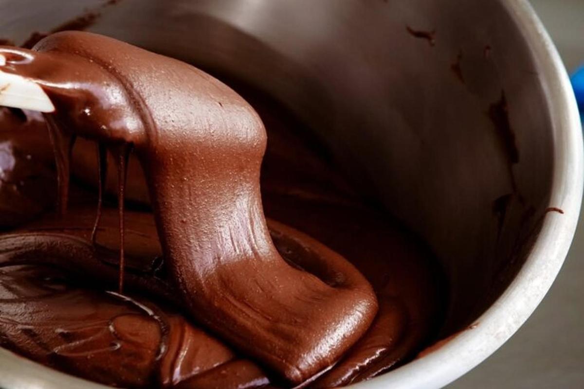 a chocolate spoon in a cup of coffee