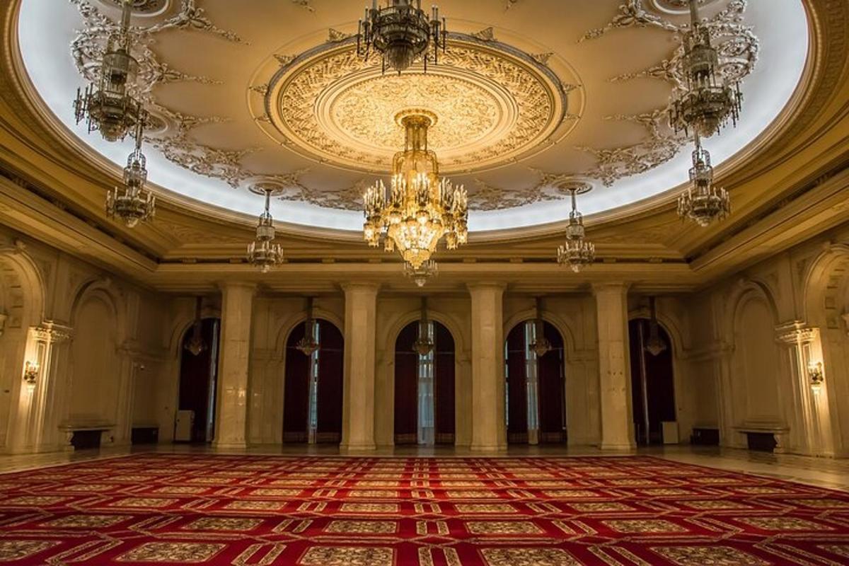 a large room with a chandelier and a red rug