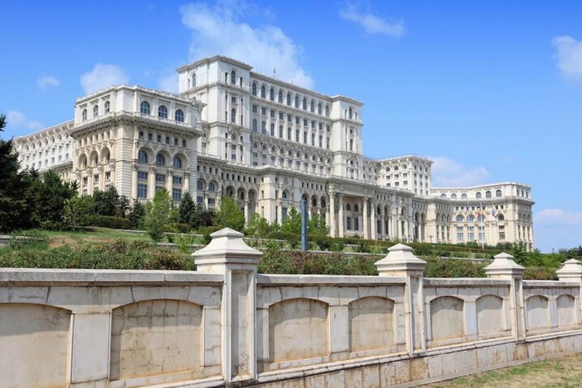 a large white building with a fence in front of it