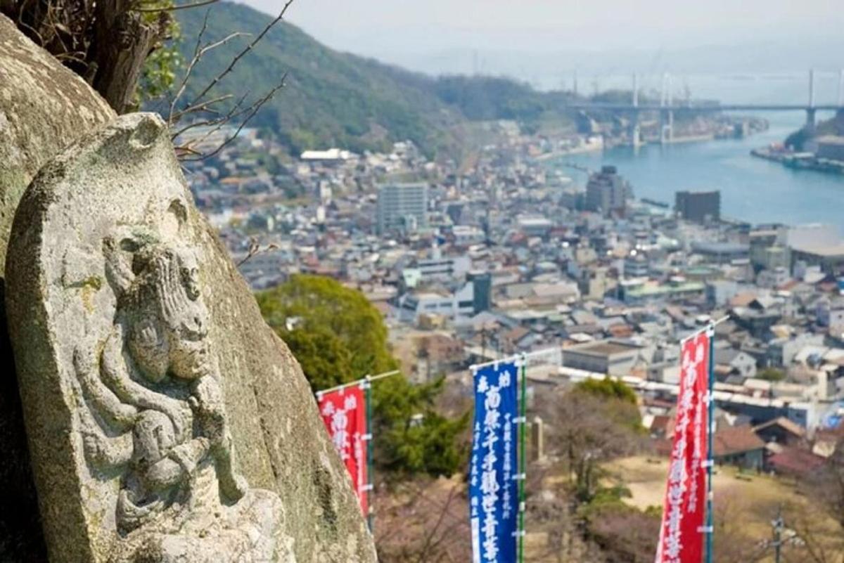 a stone statue of a snakes head on a hill overlooking a city