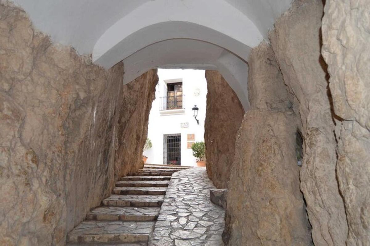 a stone alley way with stairs in a building