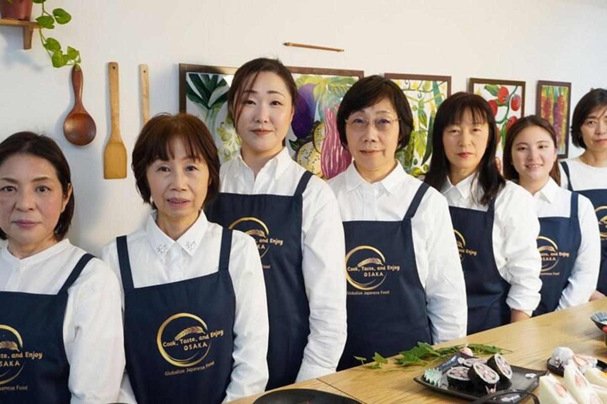 a group of women in a kitchen posing for a picture