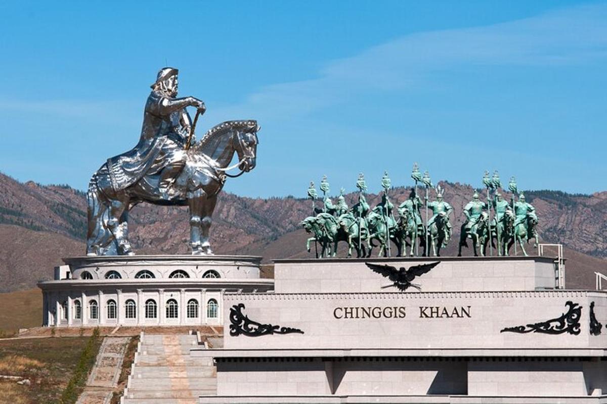 a statue of a man on a horse on top of a building